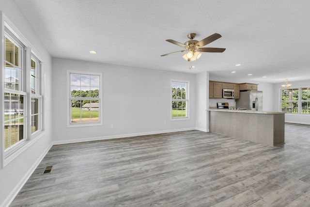 unfurnished living room featuring hardwood / wood-style floors and plenty of natural light