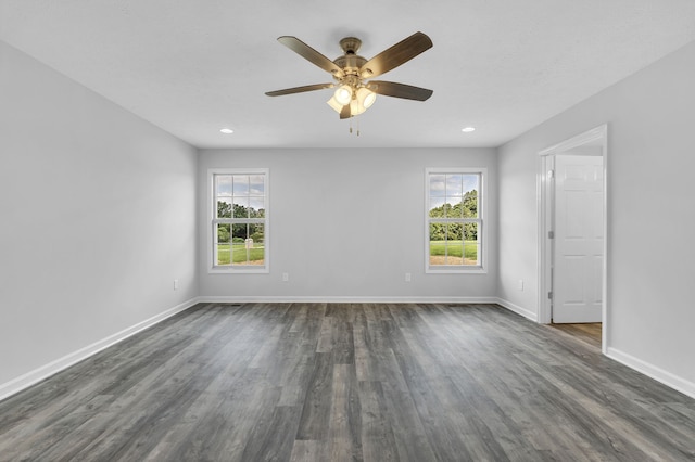 unfurnished room featuring ceiling fan and dark wood-type flooring