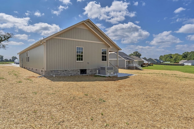 rear view of house featuring a lawn and a patio area