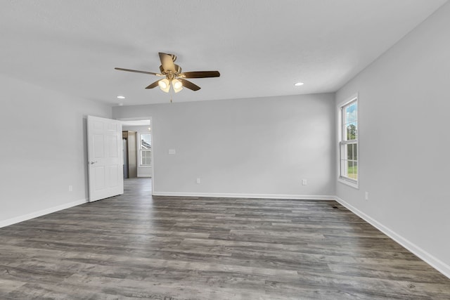 empty room with ceiling fan and hardwood / wood-style flooring