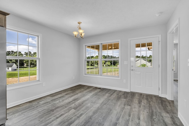 foyer with wood-type flooring and a chandelier