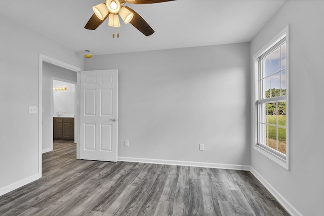 empty room featuring ceiling fan and hardwood / wood-style floors