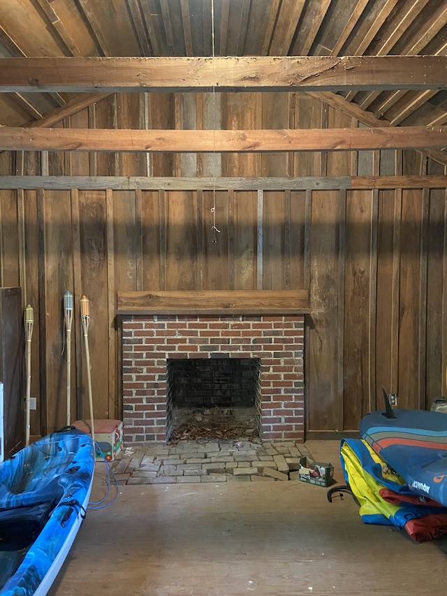 interior space featuring wooden walls and a brick fireplace