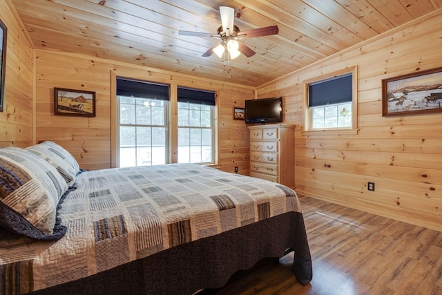 bedroom featuring wood ceiling, wood-type flooring, and wooden walls