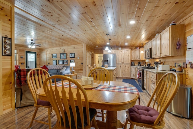 dining area featuring light wood-type flooring, wooden walls, wood ceiling, and ceiling fan