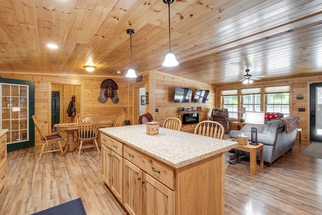 kitchen featuring a kitchen island, light hardwood / wood-style floors, hanging light fixtures, and light brown cabinetry