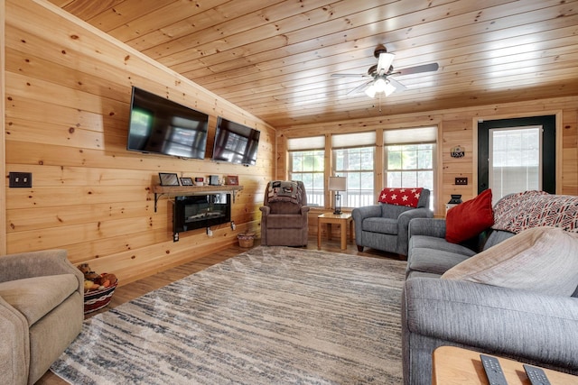 living room featuring hardwood / wood-style floors, wooden walls, ceiling fan, and wood ceiling