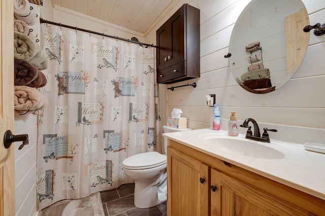 bathroom featuring toilet, wooden walls, curtained shower, and vanity