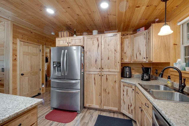 kitchen with stainless steel appliances, light brown cabinets, and sink