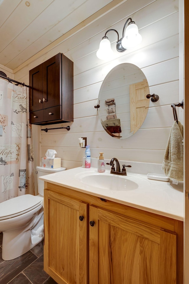 bathroom featuring vanity, a shower with shower curtain, and toilet