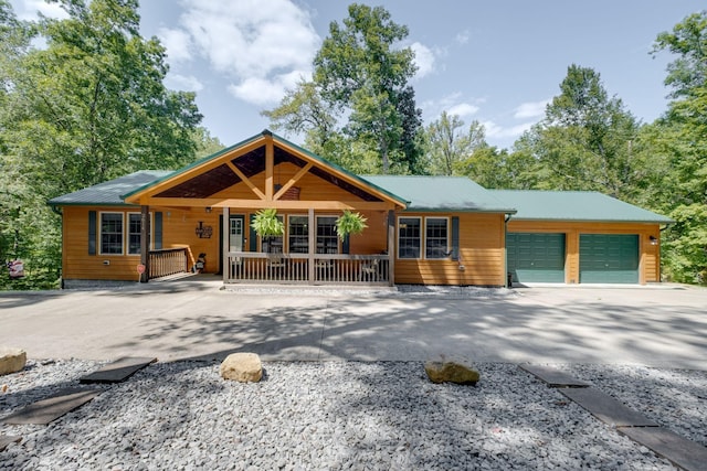 view of front of house featuring covered porch and a garage