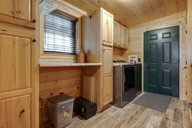 kitchen with wood walls, separate washer and dryer, light hardwood / wood-style floors, light brown cabinetry, and wood ceiling