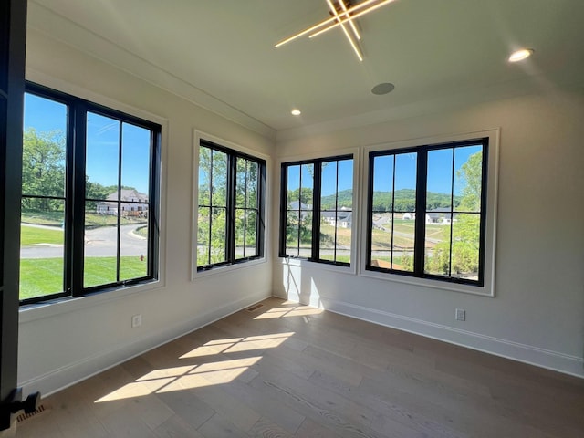 unfurnished sunroom featuring visible vents