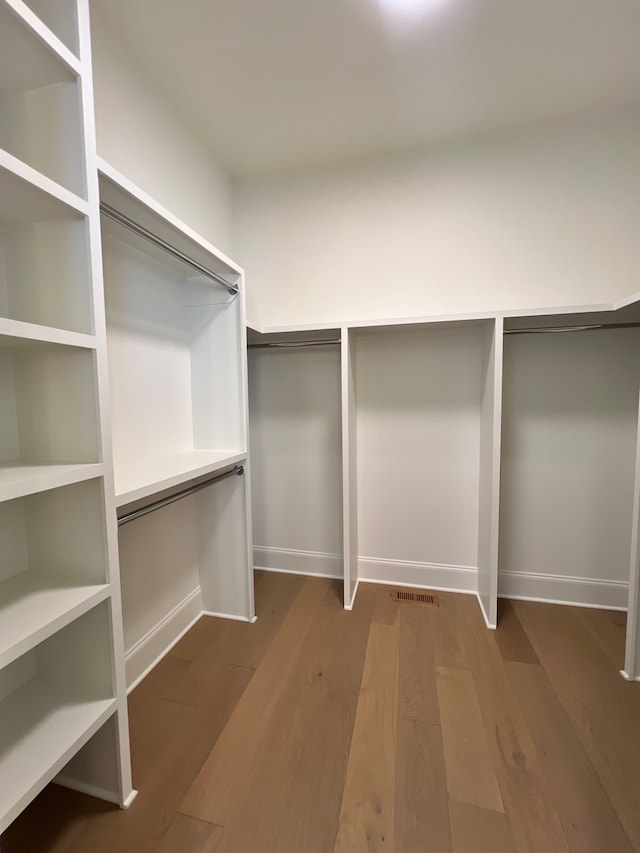 walk in closet featuring hardwood / wood-style flooring