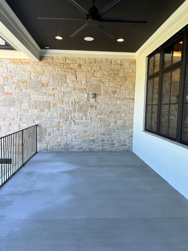 view of patio with ceiling fan and a balcony