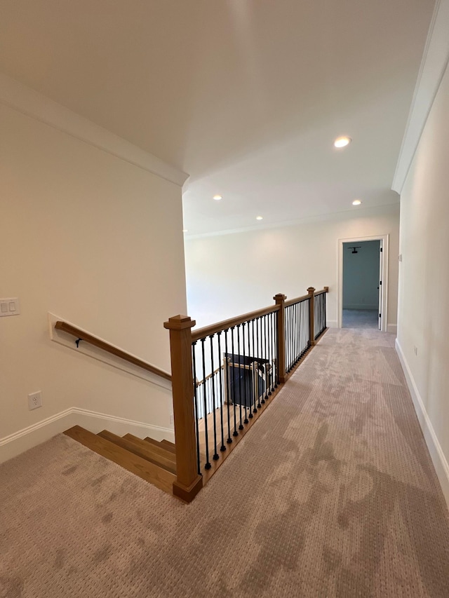 corridor featuring crown molding, carpet, baseboards, an upstairs landing, and recessed lighting