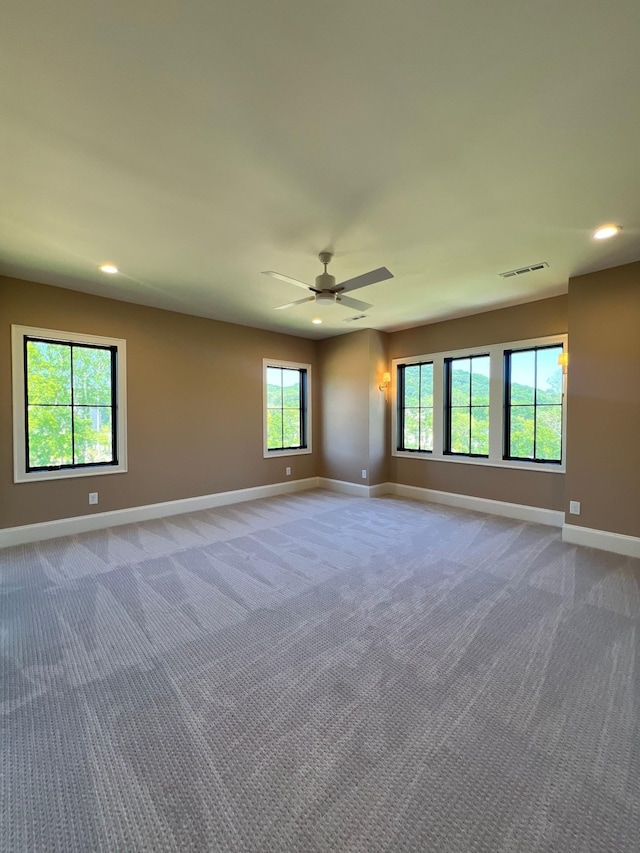 carpeted empty room with visible vents, recessed lighting, a ceiling fan, and baseboards