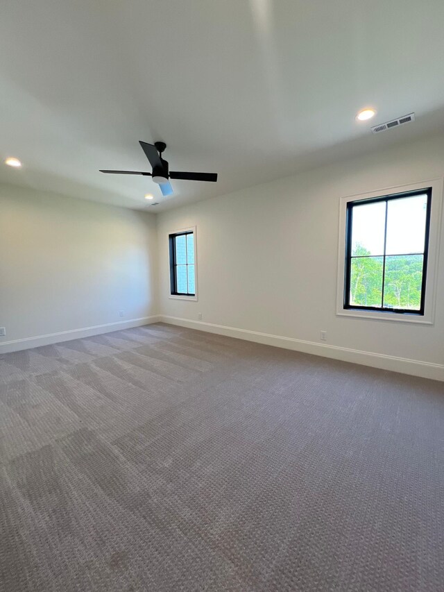 empty room with carpet floors and ceiling fan