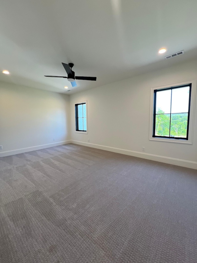 spare room with visible vents, recessed lighting, carpet, and baseboards