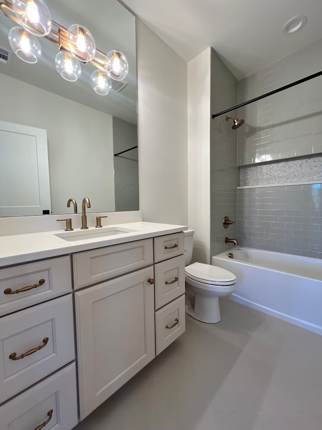 full bathroom with tiled shower / bath, vanity, toilet, and tile patterned floors