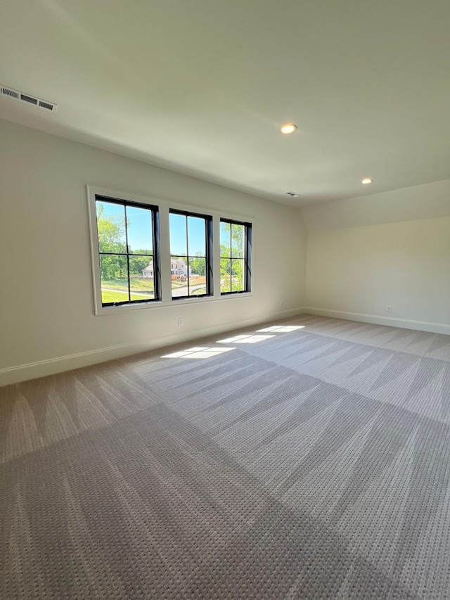 empty room with light carpet, visible vents, recessed lighting, and baseboards