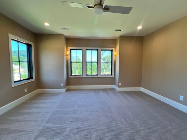 carpeted spare room with visible vents, recessed lighting, and baseboards