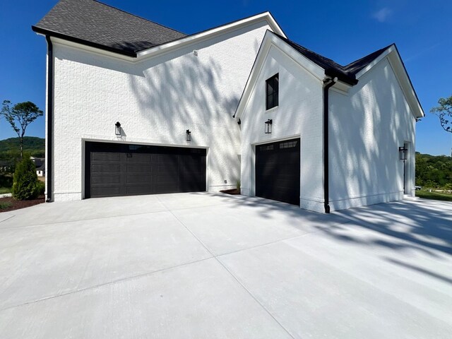 view of side of home featuring a garage