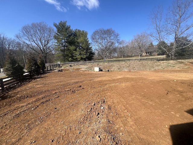 view of yard with a rural view and fence