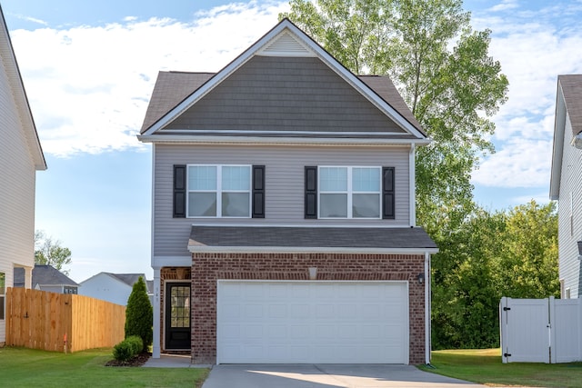 view of front of house featuring a garage and a front lawn