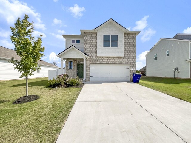 view of front of home with a garage and a front lawn