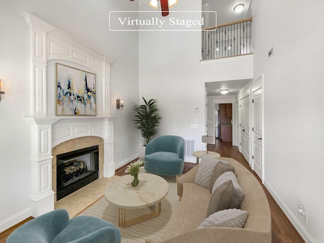 living room with a high ceiling and hardwood / wood-style floors