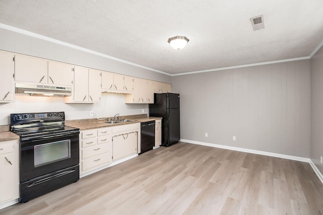 kitchen with under cabinet range hood, a sink, light wood-type flooring, black appliances, and crown molding