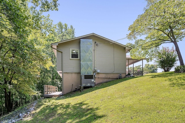 view of property exterior with a carport and a yard