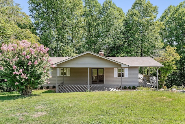 view of front of property with a porch, a front yard, and a chimney