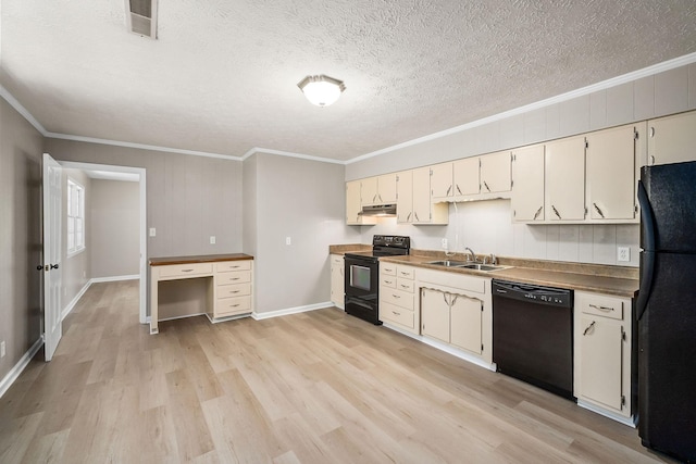 kitchen featuring a textured ceiling, a sink, light wood-style floors, black appliances, and crown molding