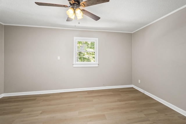 empty room with ornamental molding, baseboards, a textured ceiling, and light wood finished floors