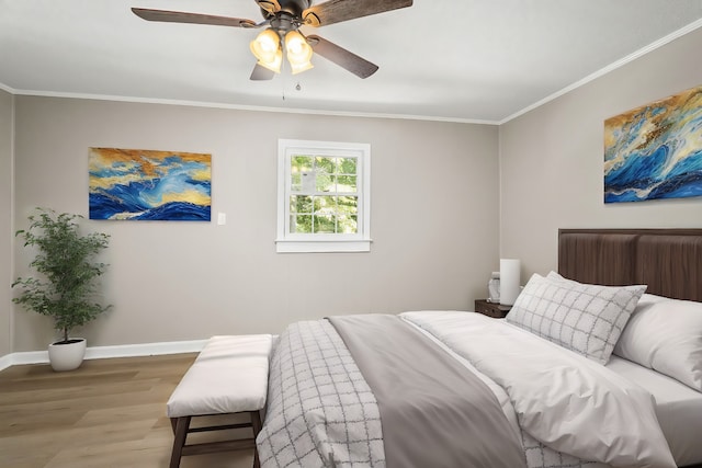 bedroom with ceiling fan, ornamental molding, wood finished floors, and baseboards