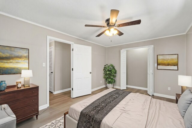 bedroom with baseboards, ornamental molding, and wood finished floors