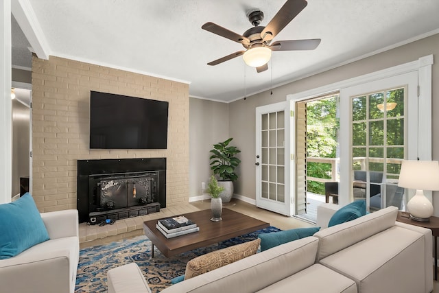 living area featuring a textured ceiling, a fireplace, a ceiling fan, and crown molding