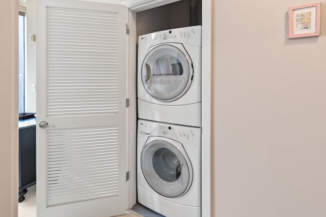 washroom with stacked washer and dryer