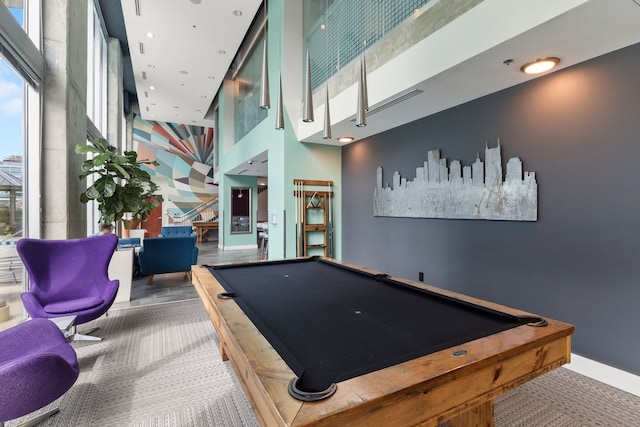 game room featuring pool table, carpet, and a towering ceiling