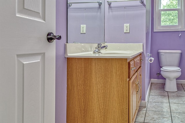 bathroom with vanity, toilet, and tile patterned flooring