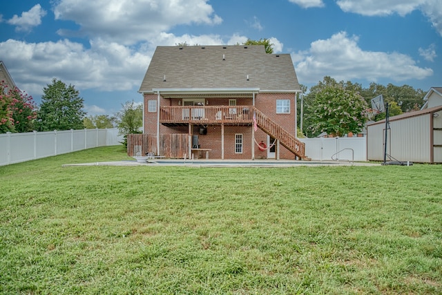 rear view of property with a yard and a wooden deck