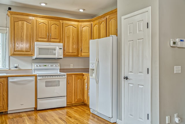 kitchen with light wood-type flooring and white appliances