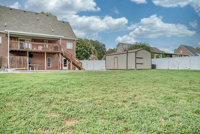 view of yard featuring a shed and a deck