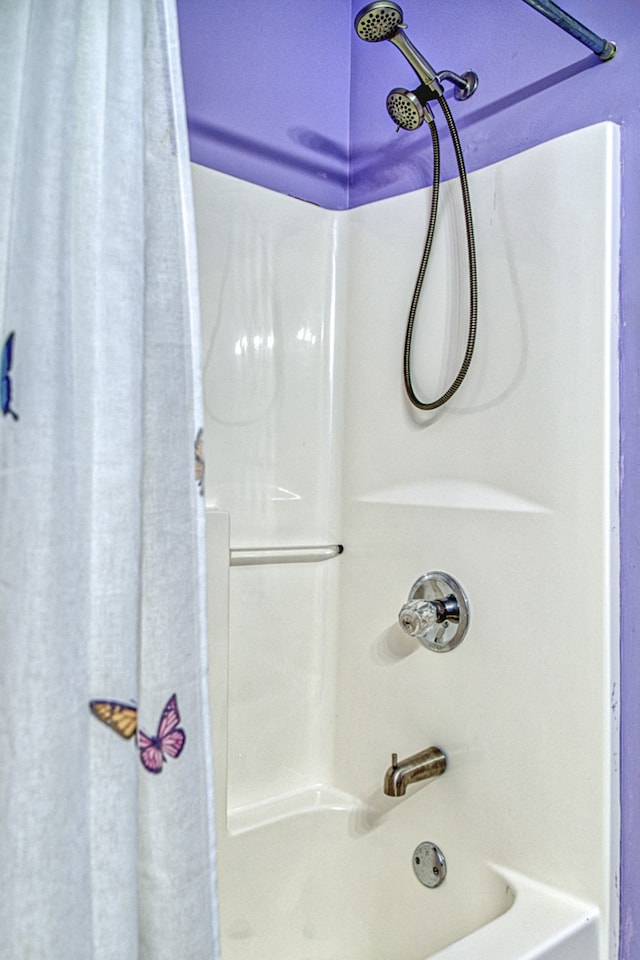 bathroom with shower / bath combination with curtain