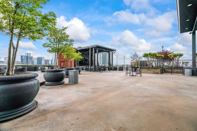 view of patio / terrace featuring a city view and fence