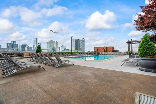 view of swimming pool featuring a pergola and a patio