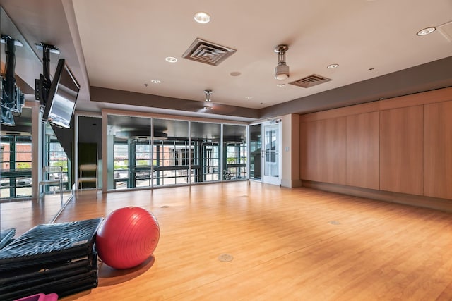 exercise area featuring a wealth of natural light, visible vents, wood finished floors, and recessed lighting