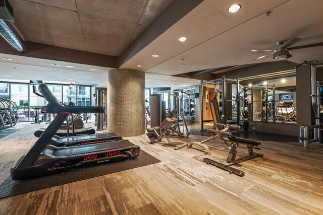 workout area featuring ceiling fan and hardwood / wood-style floors